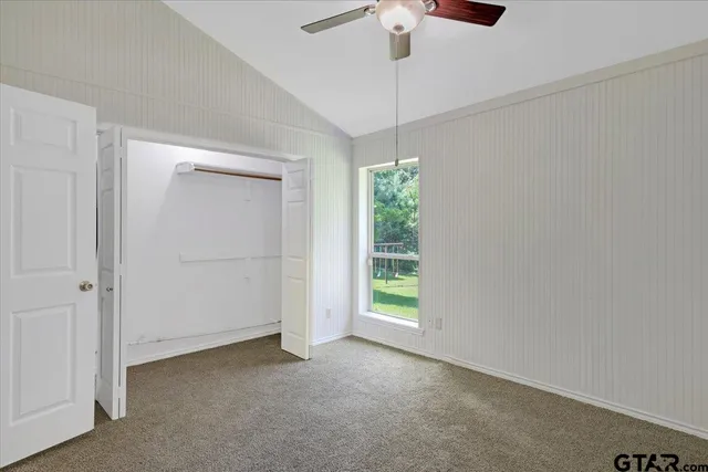 an empty room with a empty space and a ceiling fan