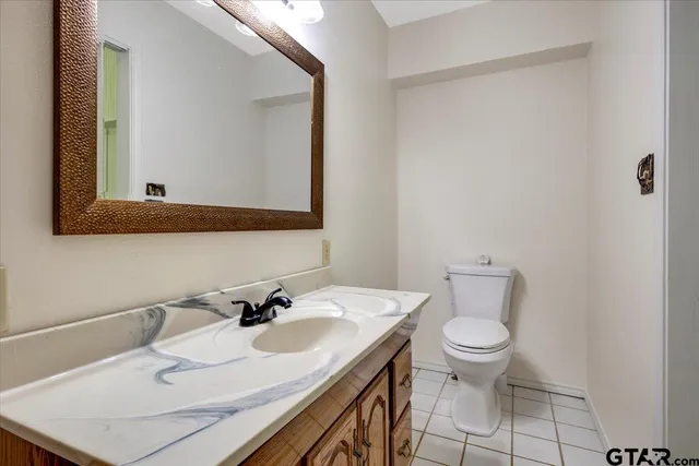 a bathroom with a sink toilet and mirror
