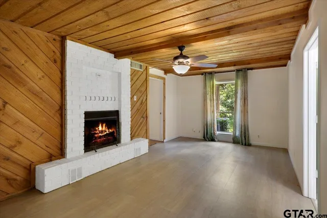 a view of an empty room with a fireplace