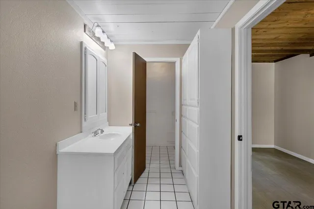 a bathroom with a double vanity sink and mirror