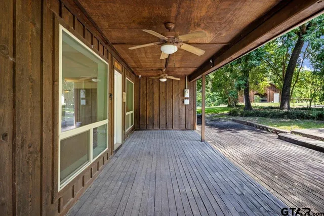 a view of balcony with wooden floor and fence