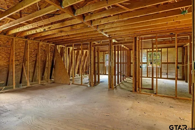 a view of a backyard with a large tree