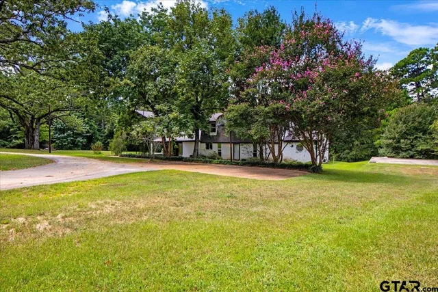 a swimming pool with outdoor seating and yard