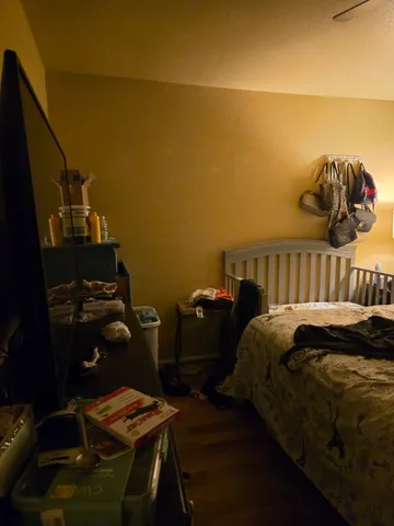 a bed sitting in a bedroom next to a window