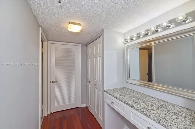 a spacious bedroom with a bed and a chandelier
