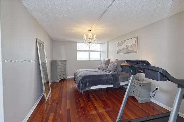 a bedroom with a large bed and dresser