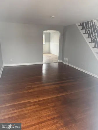 a view of room and hall with wooden floor