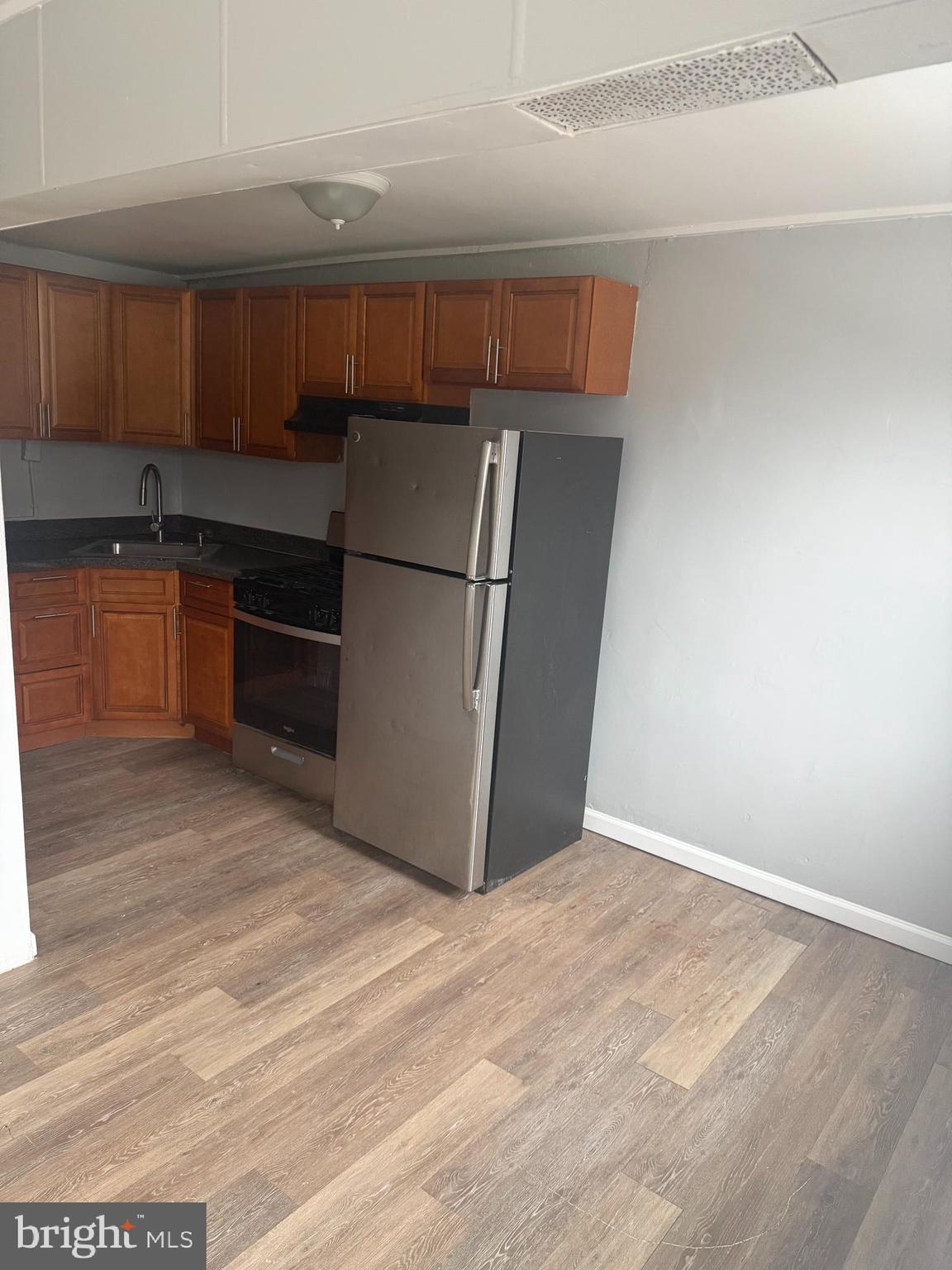 203 Cambridge Road Clifton Heights, PA 19018 - Photo 5 of 13 a kitchen with granite countertop a refrigerator and a stove top oven