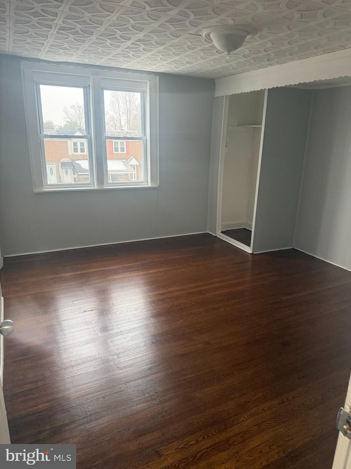 203 Cambridge Road Clifton Heights, PA 19018 - Photo 9 of 13 an empty room with wooden floor and windows