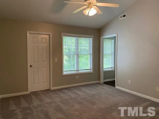 a view of an empty room with a window