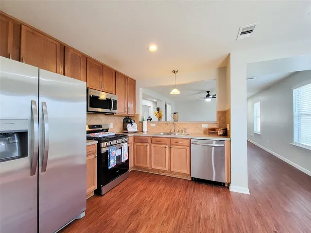 a kitchen with a stove a sink and a microwave