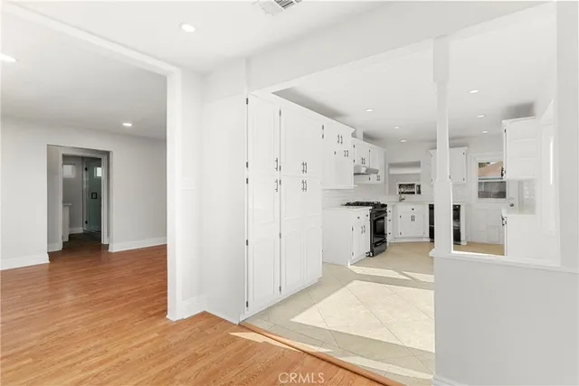 a view of a kitchen with wooden floor and a window