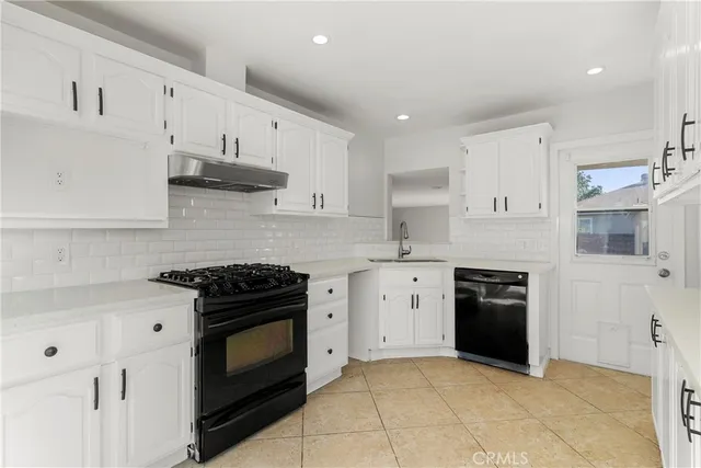 a kitchen with cabinets appliances and a sink