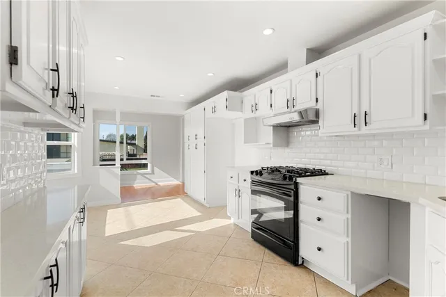 a kitchen with stainless steel appliances granite countertop a stove and a refrigerator