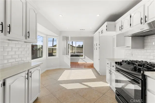 a kitchen with stainless steel appliances granite countertop a stove and a refrigerator