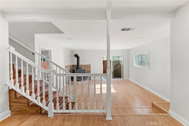 a view of entryway and hall with wooden floor