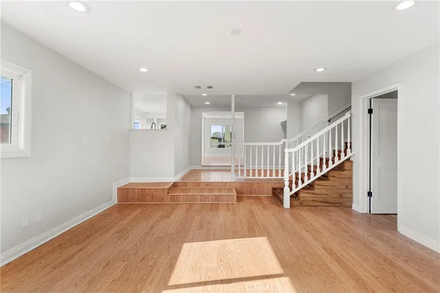 a view of entryway and hall with wooden floor