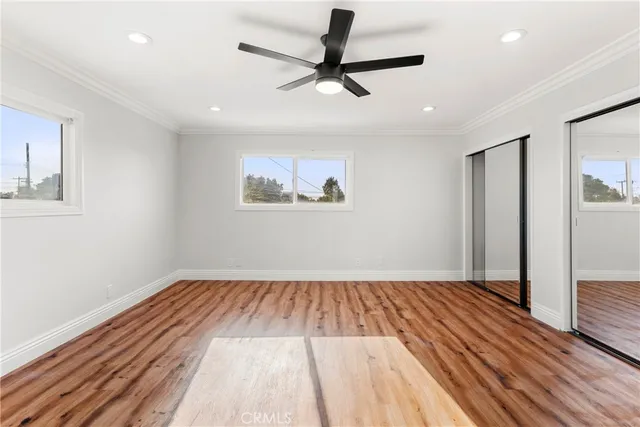 a view of empty room with wooden floor