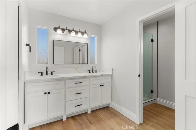 a bathroom with a double vanity sink and a mirror