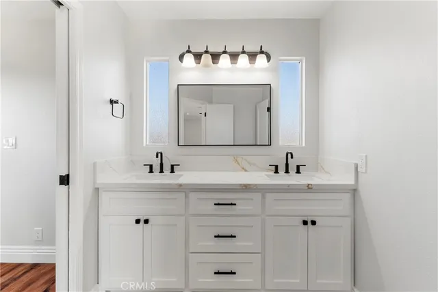 a bathroom with a sink vanity and a mirror