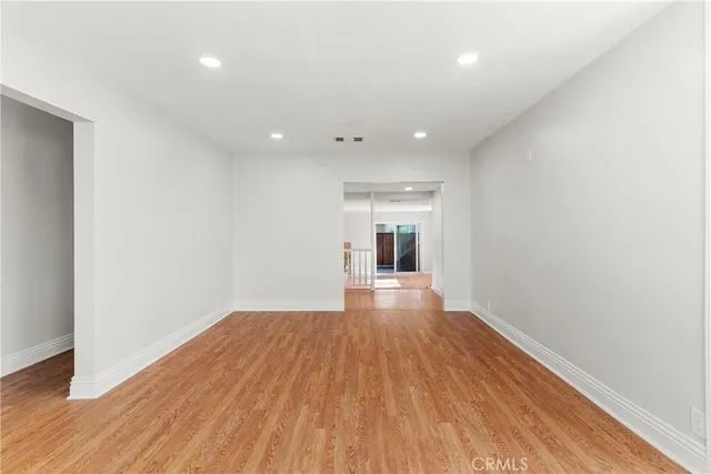 a view of a room with wooden floor and a window