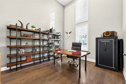a view of a workspace with furniture and a book shelf