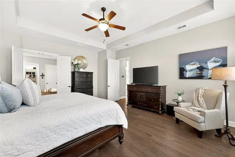 a bedroom with a bed and a television