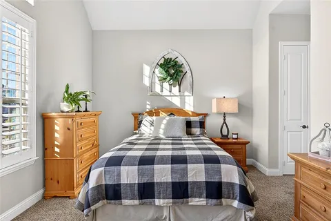 a bedroom with a bed lamps and window