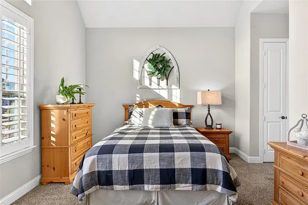 a bedroom with a bed lamps and window