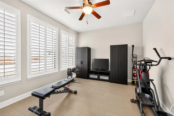 a room with gym equipment and windows