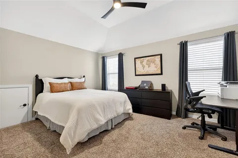 a bed room with a bed and a desk