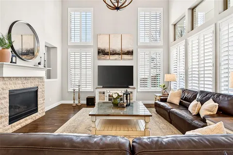 a living room with furniture fireplace and a large window