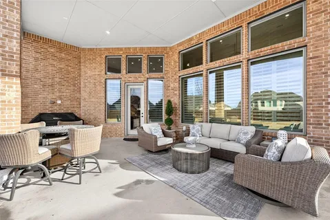 a balcony with furniture and a potted plant