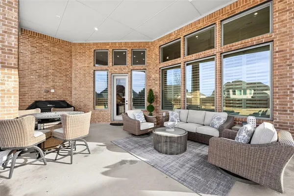 a balcony with furniture and a potted plant