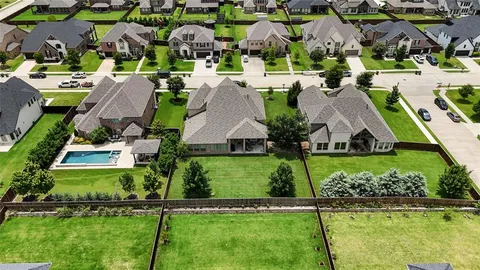 an aerial view of multiple houses with yard