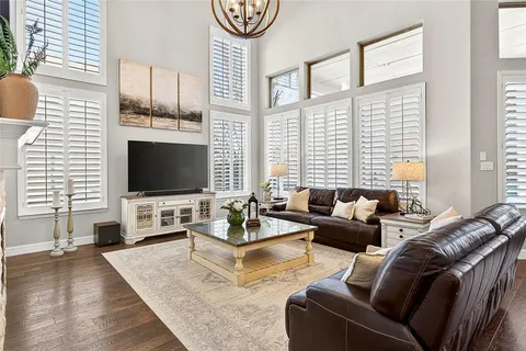 a living room with fireplace furniture and a flat screen tv