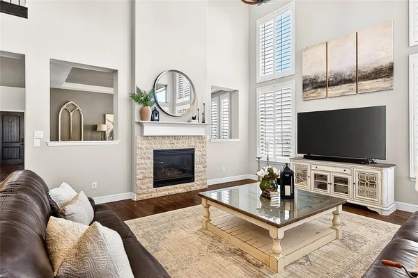 a living room with furniture a flat screen tv and a fireplace