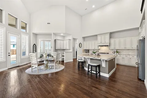 a large kitchen with a table and chairs in it