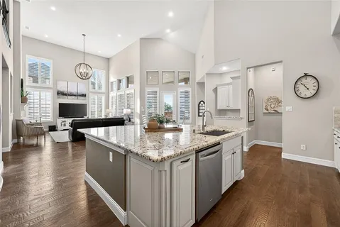 a kitchen with stainless steel appliances granite countertop a lot of counter space and wooden floor
