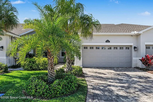 a view of a house with a yard and a garage