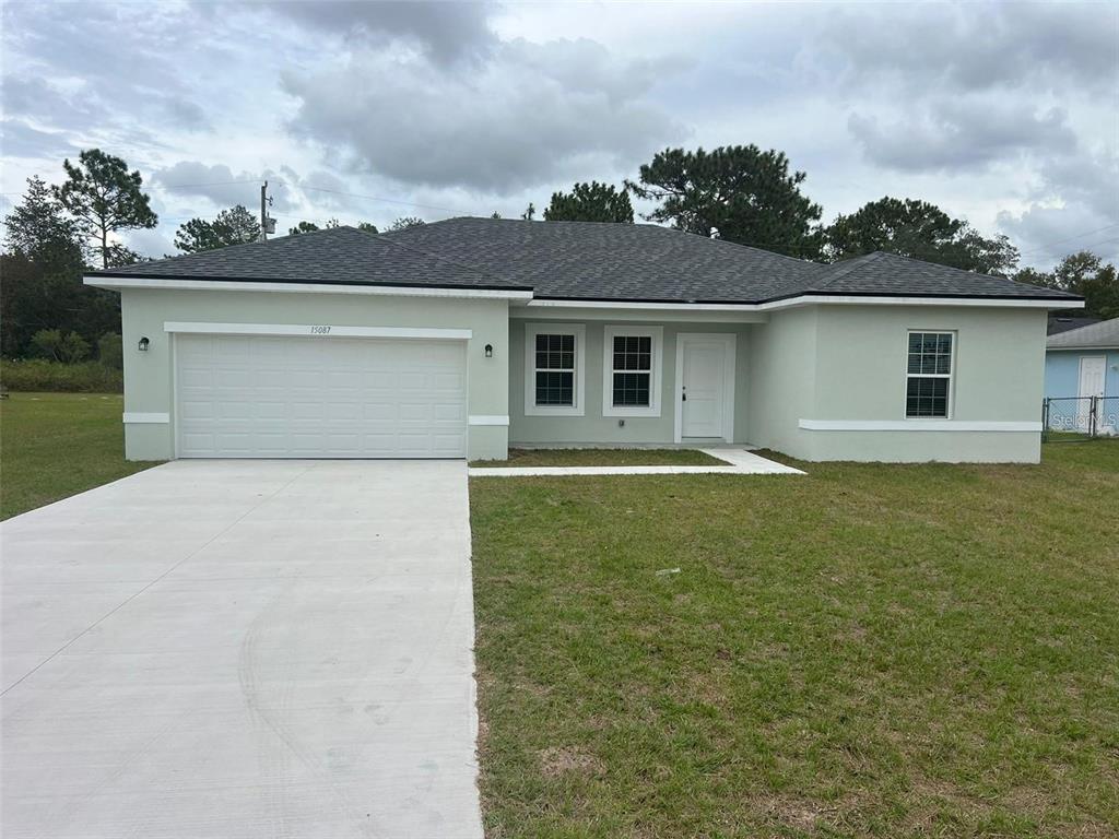 15087 Southwest 51st Terrace Ocala, FL 34473 - Photo 1 of 14 front view of a house with a yard