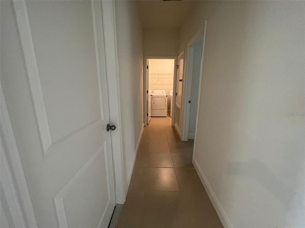 15087 Southwest 51st Terrace Ocala, FL 34473 - Photo 9 of 14 a view of a hallway with wooden floor