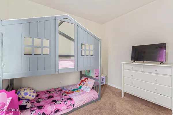 a bedroom with a bed and flat screen tv
