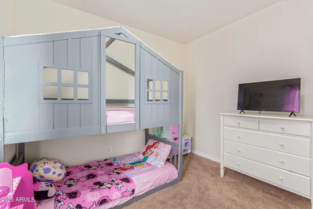 a bedroom with a bed and flat screen tv