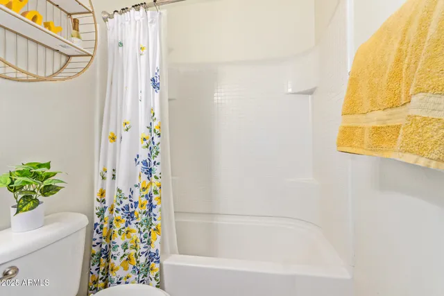a bathroom with a bathtub and shower