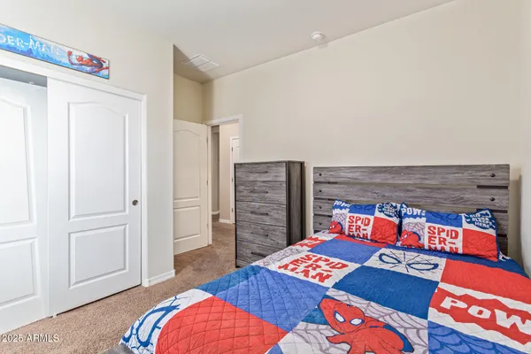 a bedroom with a bed and a book shelf