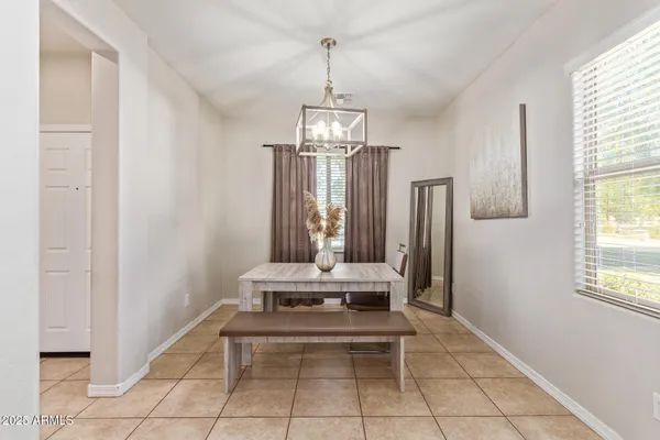 a view of a house with backyard and a tree