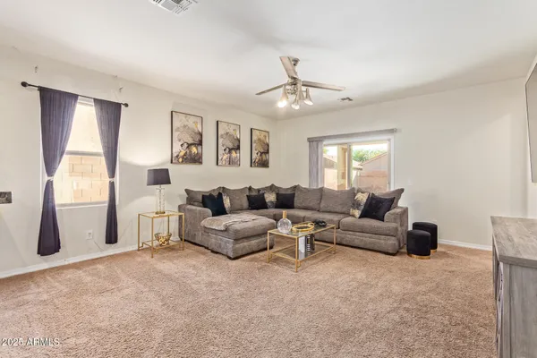 a living room with furniture and a large window