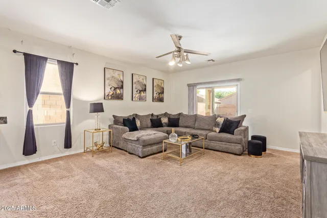 a living room with furniture and a large window
