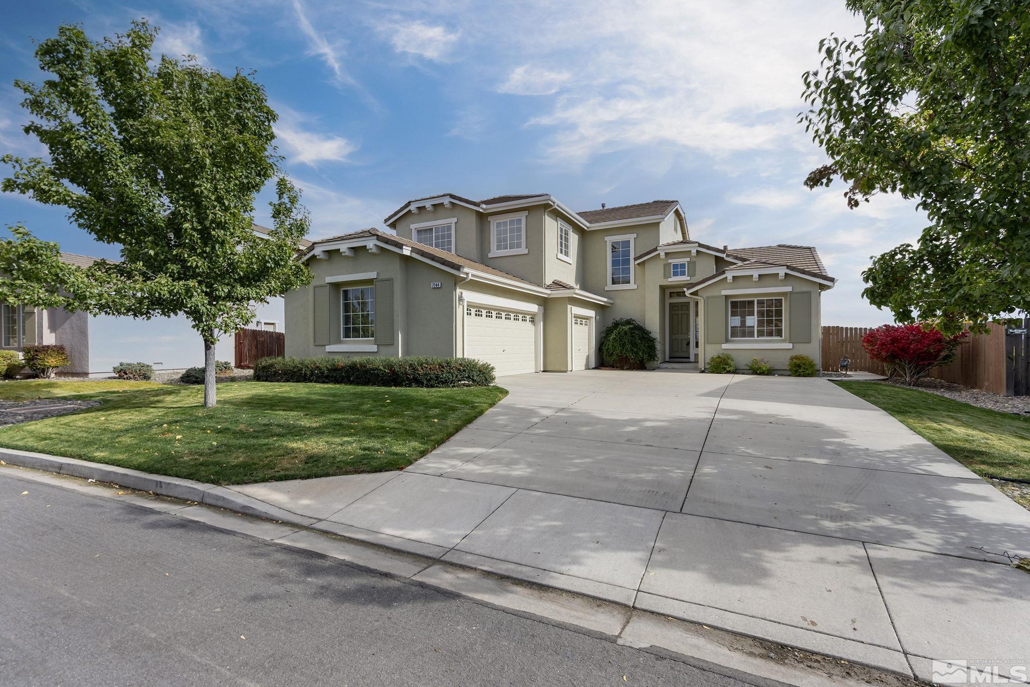 7144 Crest Hill Drive Reno, NV 89506 - Photo 1 of 28 a front view of a house with a garden